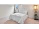 Bedroom featuring plush carpet, a window with curtains, and a modern floor lamp at 201 Wright St # 106, Lakewood, CO 80228
