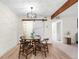 Dining area with wood floors, decorative light fixture, a closet, and open access to another room at 201 Wright St # 106, Lakewood, CO 80228