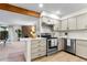 Modern kitchen and living room with a view to the stone fireplace and bright interior at 201 Wright St # 106, Lakewood, CO 80228