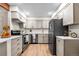 Modern kitchen with stainless steel appliances, wood floors, white countertops, and light gray cabinets at 201 Wright St # 106, Lakewood, CO 80228