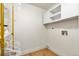 Laundry room with vinyl wood floors, shelving and new white cabinets at 201 Wright St # 106, Lakewood, CO 80228