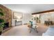 Open concept living room with view into kitchen, dining, stone fireplace and neutral decor at 201 Wright St # 106, Lakewood, CO 80228