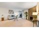 Bright living room with a stone fireplace, sliding glass doors, neutral decor, and modern furnishings at 201 Wright St # 106, Lakewood, CO 80228