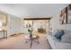 Bright living room leading into the kitchen and dining area with modern decor and neutral tones at 201 Wright St # 106, Lakewood, CO 80228
