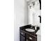 Bathroom with dark cabinets, granite counters, modern lighting, and stylish fixtures at 13055 E Dakota Ave, Aurora, CO 80012