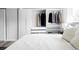 Bright bedroom featuring custom closets, wood floors, and a window offer an organized, modern, and spacious retreat at 13055 E Dakota Ave, Aurora, CO 80012