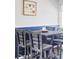 Dining room features modern table and chairs, and a butterfly painting hanging on the wall at 13055 E Dakota Ave, Aurora, CO 80012