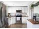 Kitchen with stainless steel appliances, granite counters, white cabinets, and an open layout at 13055 E Dakota Ave, Aurora, CO 80012