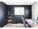 Home office features a modern desk setup, built-in shelving, and plenty of natural light at 13055 E Dakota Ave, Aurora, CO 80012