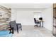 Inviting home office with a wood accent wall, a large window, and a comfortable chair for focused work at 13055 E Dakota Ave, Aurora, CO 80012