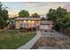 Aerial view of large deck, brick exterior, stone fire pit, and backyard at 13055 E Dakota Ave, Aurora, CO 80012