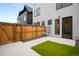 The backyard offers a seamless transition from indoor to outdoor living, featuring a gate and private fenced yard at 2179 S Bannock St, Denver, CO 80223