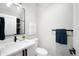A modern bathroom features a sleek vanity, toilet, and dark fixtures at 2179 S Bannock St, Denver, CO 80223