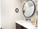 Modern half bathroom featuring sleek fixtures and a decorative mirror at 2179 S Bannock St, Denver, CO 80223