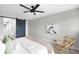 A bright bedroom showcases a ceiling fan, modern decor, and a stylish sliding barn door to the ensuite bathroom at 2179 S Bannock St, Denver, CO 80223