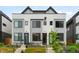 Modern townhome featuring a sleek exterior design, well-maintained landscaping, and inviting entryway at 2179 S Bannock St, Denver, CO 80223