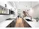 Contemporary kitchen with stainless steel appliances and open layout to living area at 2179 S Bannock St, Denver, CO 80223
