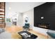 Open-concept living space with modern fireplace and seamless flow to the kitchen at 2179 S Bannock St, Denver, CO 80223