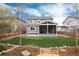 Backyard featuring a well-maintained lawn, a screened-in porch, and rock garden for outdoor enjoyment at 7844 Grady Cir, Castle Rock, CO 80108