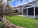 Well-maintained backyard featuring a spacious lawn, privacy fence, garden, and covered porch at 7844 Grady Cir, Castle Rock, CO 80108