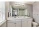 Bathroom with dual sinks, a large mirror and good lighting at 7844 Grady Cir, Castle Rock, CO 80108