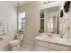 Clean bathroom with a white vanity, toilet, and a glimpse into a tiled shower area at 7844 Grady Cir, Castle Rock, CO 80108