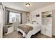 Inviting bedroom with natural light, custom shelving, and calming gray accents at 7844 Grady Cir, Castle Rock, CO 80108