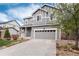 Gray two-story home featuring a large driveway and a well-manicured lawn at 7844 Grady Cir, Castle Rock, CO 80108