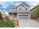 Charming gray two-story home with a well-manicured lawn and attached two-car garage at 7844 Grady Cir, Castle Rock, CO 80108