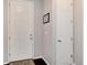 Light and bright foyer with a white door, dark floors, and neutral paint at 7844 Grady Cir, Castle Rock, CO 80108