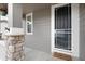 Close-up of the front entrance with stone pillar, welcome mat and storm door at 7844 Grady Cir, Castle Rock, CO 80108