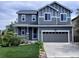 Charming two-story home with a manicured lawn, attached two-car garage, and inviting front porch at 7844 Grady Cir, Castle Rock, CO 80108