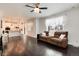Cozy living room with an open floor plan, hardwood floors, and a kitchen featuring stainless steel appliances at 7844 Grady Cir, Castle Rock, CO 80108