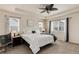 Bright main bedroom with neutral carpet, a ceiling fan, and windows, creating a peaceful retreat at 7844 Grady Cir, Castle Rock, CO 80108