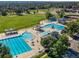 Aerial view of community pools, playground, recreation center, and green spaces at 16309 Hedgeway Dr, Parker, CO 80134