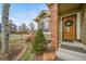 Inviting home featuring a striking front door, brickwork, and lush garden elements at 16309 Hedgeway Dr, Parker, CO 80134