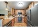 Efficient kitchen featuring stainless steel appliances, light wood cabinetry, and tiled floors at 16309 Hedgeway Dr, Parker, CO 80134