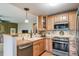 Well-maintained kitchen area with stainless steel appliances and light wood cabinets at 16309 Hedgeway Dr, Parker, CO 80134