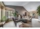 Cozy living room featuring a vaulted ceiling, large windows, and stylish furniture at 16309 Hedgeway Dr, Parker, CO 80134