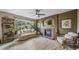 Living room with a brick fireplace, a large window, and neutral colors at 16309 Hedgeway Dr, Parker, CO 80134