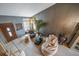Bright living room showcasing an accent wall, large windows, and a decorative entry door at 16309 Hedgeway Dr, Parker, CO 80134