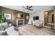Living room featuring a brick fireplace, olive-colored walls, and vinyl plank flooring at 16309 Hedgeway Dr, Parker, CO 80134