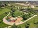 Aerial view of neighborhood park with walking paths, benches, playground and tennis courts at 16309 Hedgeway Dr, Parker, CO 80134