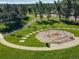 Aerial view of community playground with swings, walking paths, benches and picnic tables in a green space at 16309 Hedgeway Dr, Parker, CO 80134