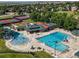 Aerial view of community pool with slide, splash pad, lap pool, tennis courts and green space at 16309 Hedgeway Dr, Parker, CO 80134