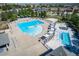Aerial view of community pool with a hot tub, lounge chairs and shade structures at 16309 Hedgeway Dr, Parker, CO 80134
