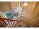Stairway landing featuring a wooden banister with a view to the living room below at 16309 Hedgeway Dr, Parker, CO 80134