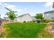 Spacious backyard with a lush lawn, privacy fence, and convenient storage shed for outdoor activities at 12845 Park Creek Way Way, Firestone, CO 80504