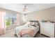 Cozy bedroom with large window, plush bedding, and a cute decorative pillows at 12845 Park Creek Way Way, Firestone, CO 80504