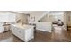 Bright and airy kitchen featuring a large center island, white cabinets, and modern appliances at 12845 Park Creek Way Way, Firestone, CO 80504